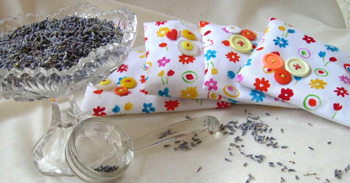 Dish of dried lavender blossoms with handmade cloth sachets for natural linen closet humidity defense
