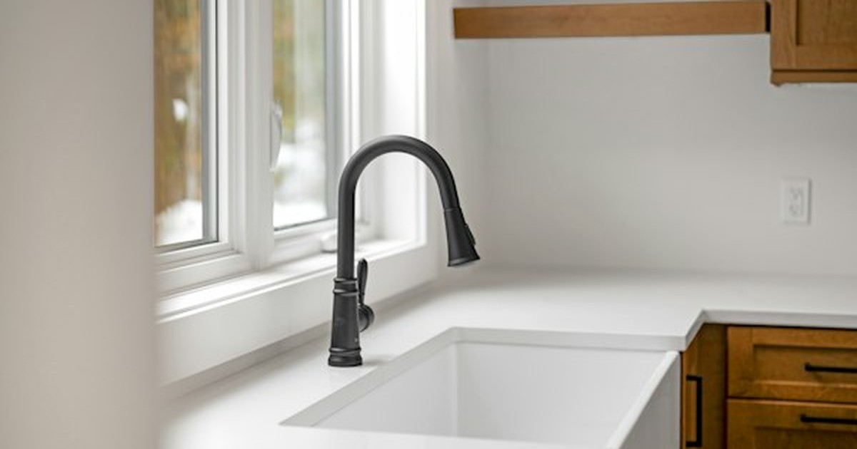 Under-sink cabinet interior showing drain pipe P-trap and supply line clearance layout