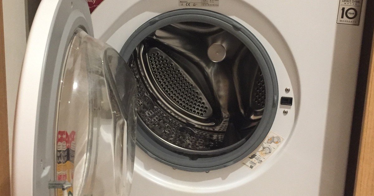 Open front-loading washing machine drum ready for cold water natural detergent wash cycle