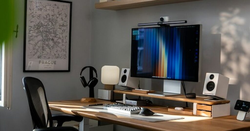 Ergonomic Home Workspace Biomechanics: Desk Height, Lumbar Support, and Monitor Eye-Level Alignment Modern ergonomic home workspace with motorized standing desk, monitor riser, and mesh office chair