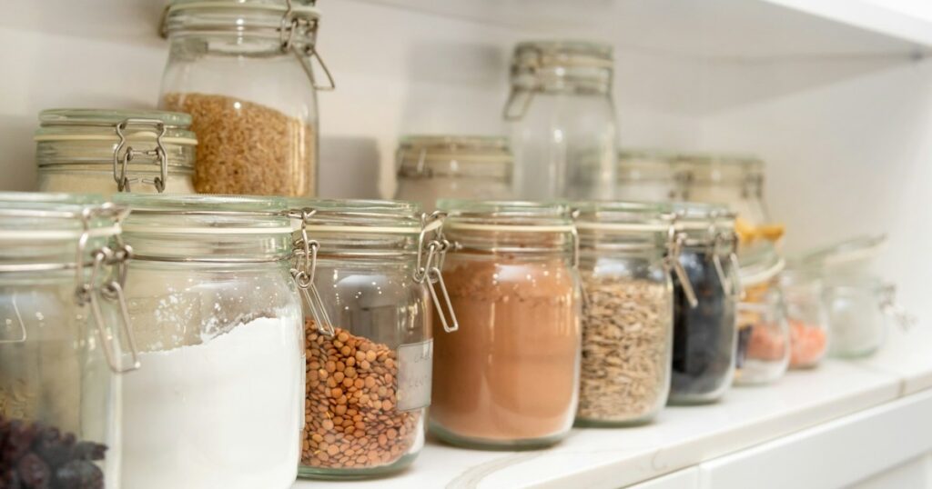 The Ultimate Kitchen Pantry Organization System: A Step-by-Step Blueprint a row of jars filled with different types of food